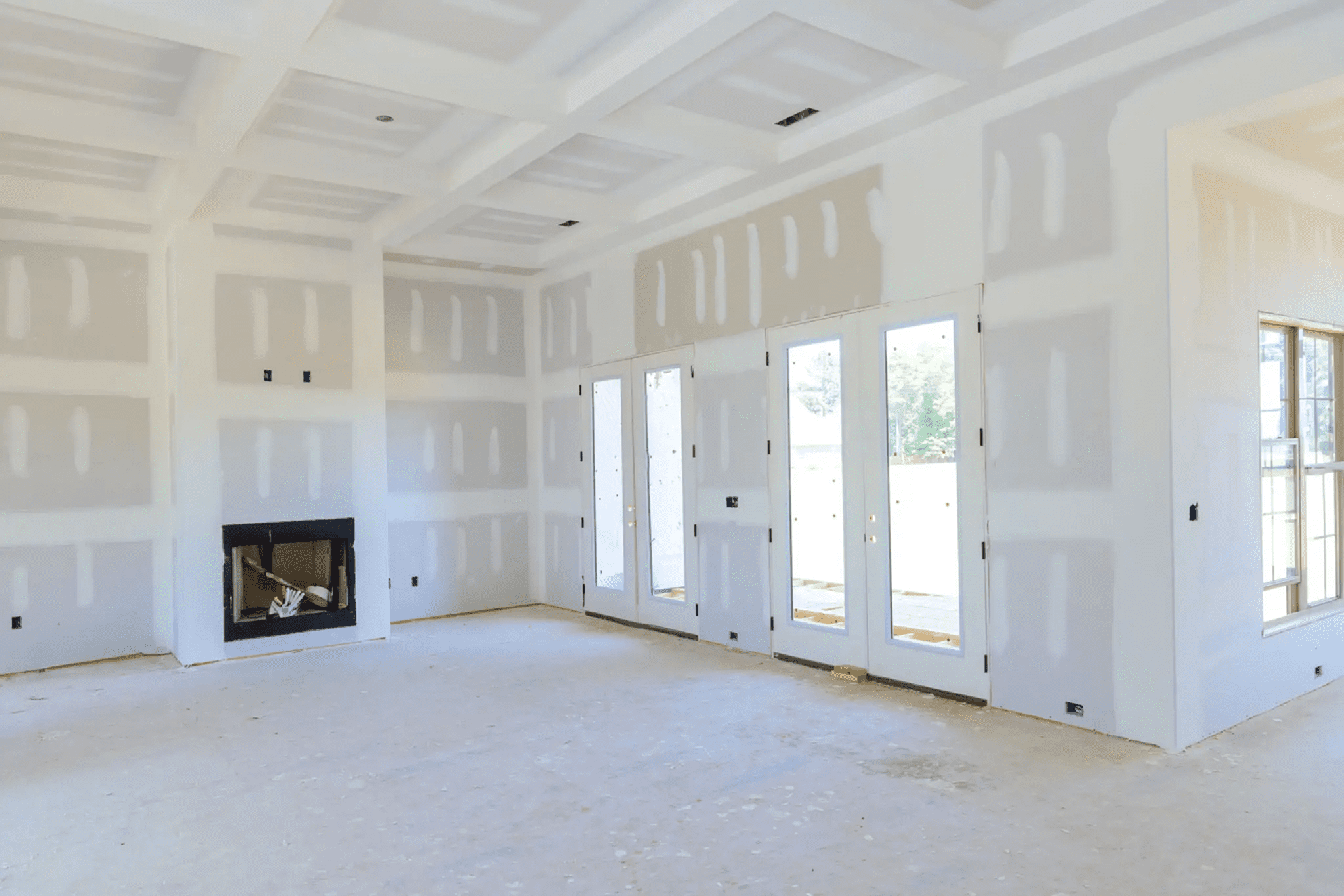 Unfinished room with drywall and fireplace
