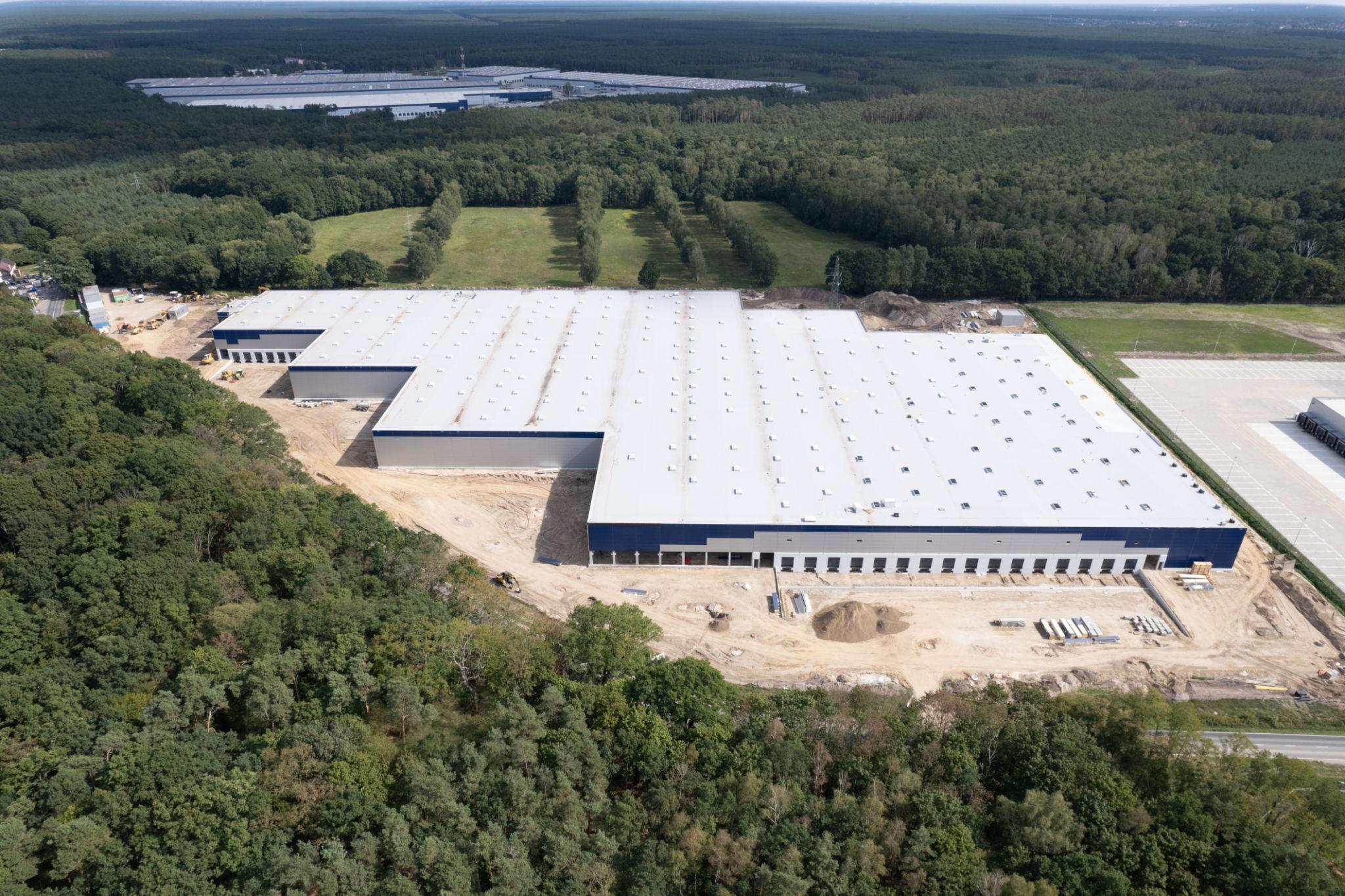 Warehouse construction site in wooded area